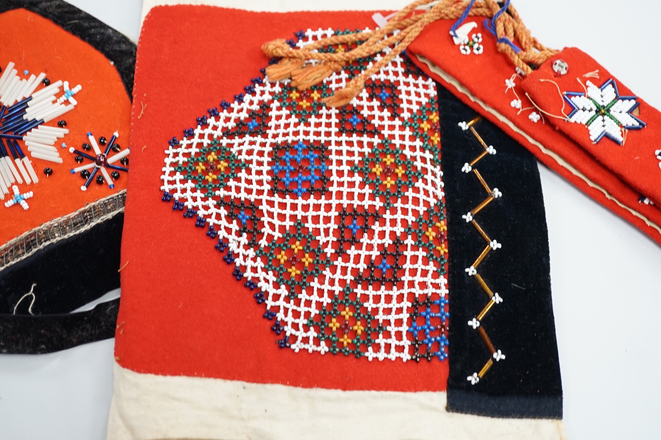 A collection of 19th century Scandinavian beadwork, worked in white and coloured geometric designs on red wood backing, (5)